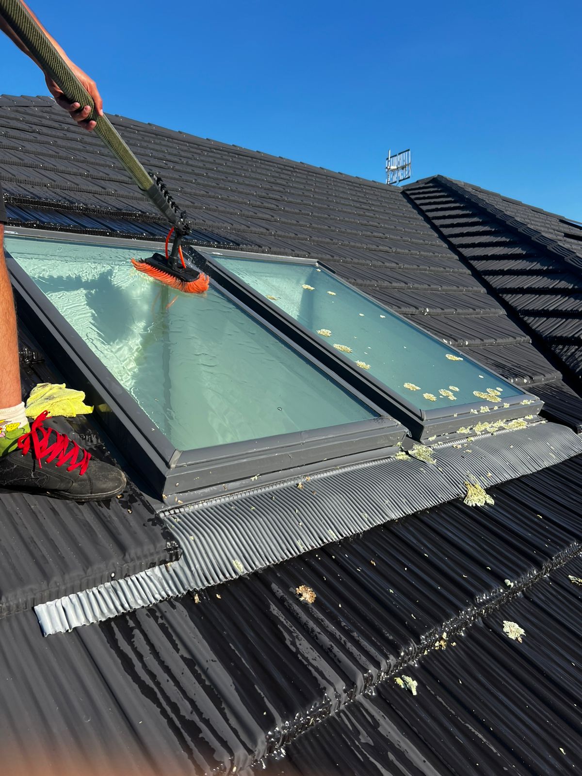 Rooftop skylight being cleaned